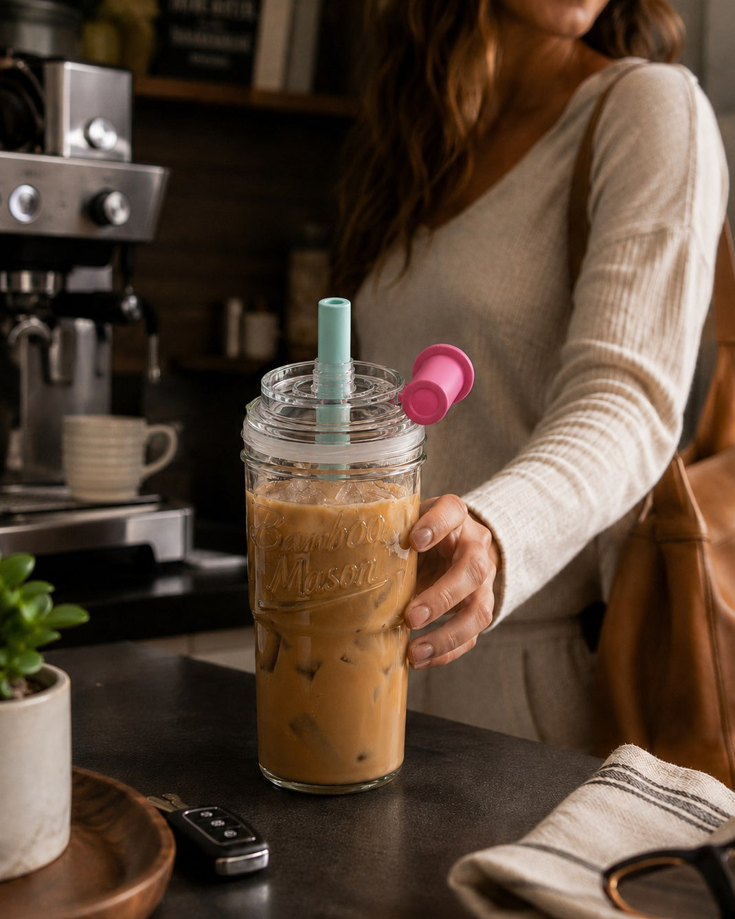 Woman carrying an ANOTION Bamboo Mason leakproof glass tumbler with iced coffee