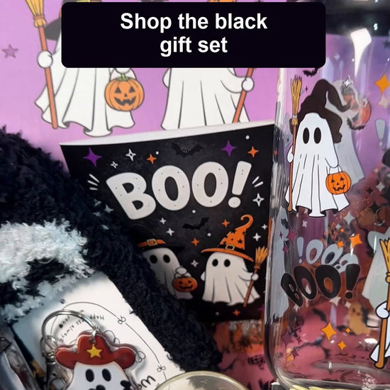 Unboxing the ANOTION black Halloween Boo Basket gift set, removing the tissue wrapping and showing its included gifts.